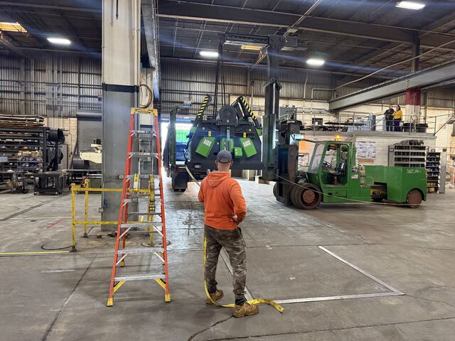 Our rigger lift walking a factory-new plate roll off the truck and into a Bensenville plant