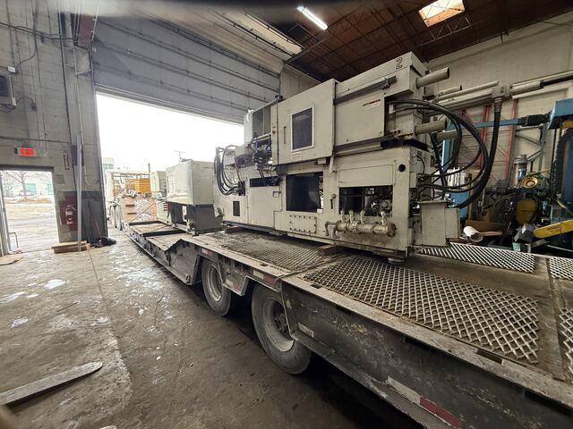 Toshiba injection molder rolling out of the plant on our lowboy, winter or not