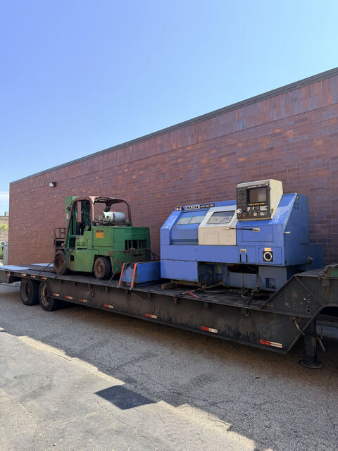 Mazak Quick Turn 10N lathe chained down on our step-deck, fresh out of a Bensenville shop -- one of our forklifts riding along