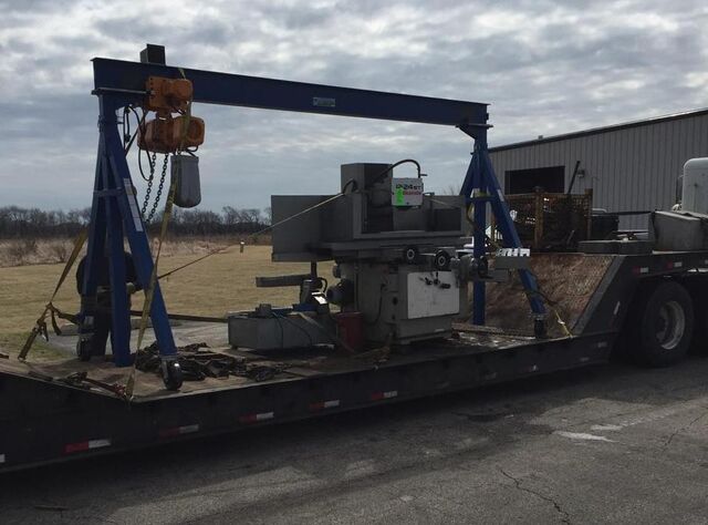 Portable gantry crane loading a surface grinder onto our trailer