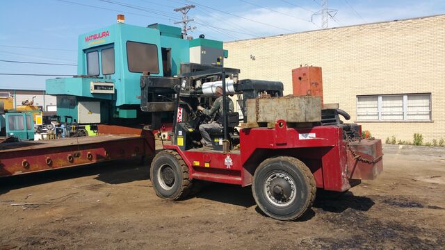 Unloading a Matsuura machining center from our lowboy trailer