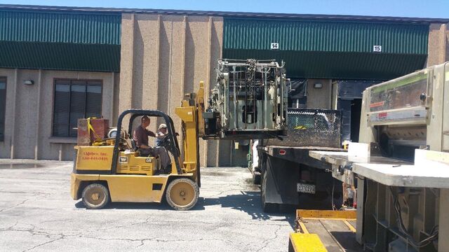 Loading a printing press unit at the customer's dock