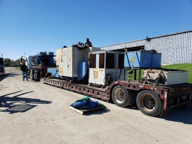 CNC machining center and support equipment strapped on our lowboy