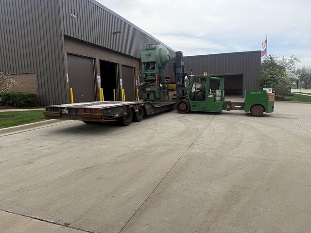 Our Versa-Lift bringing a Bliss punch press out to the lowboy at the dock