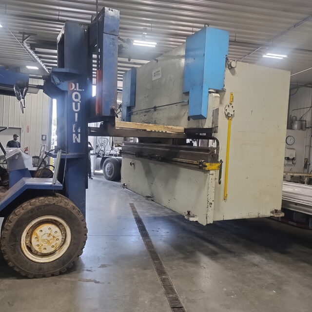 One of our 60-80,000 lb forklifts carrying a Durma press brake out of the shop