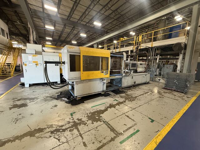 Two injection molding machines still on the plant floor, ready to come out