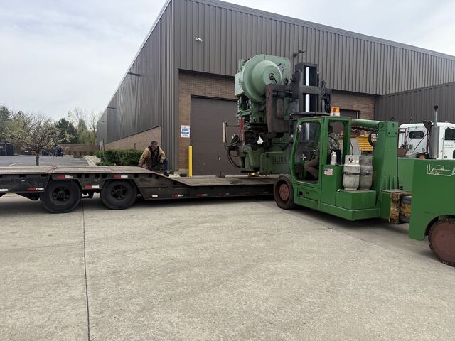 A Bliss punch press coming out onto our lowboy