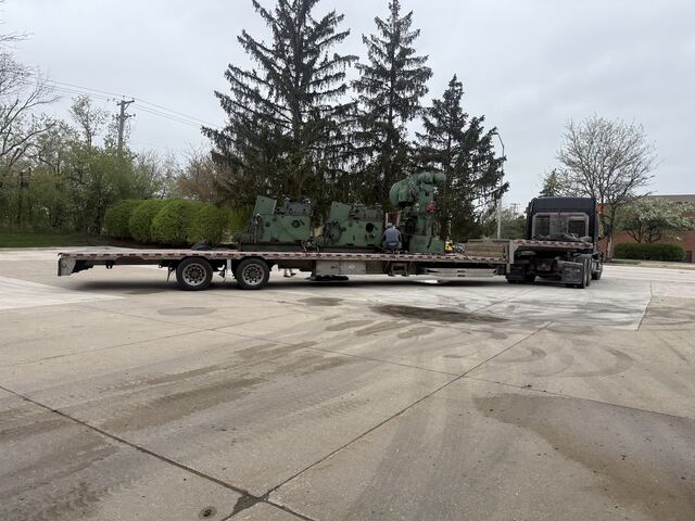 Punch presses loaded and chained down, leaving a Schaumburg industrial park