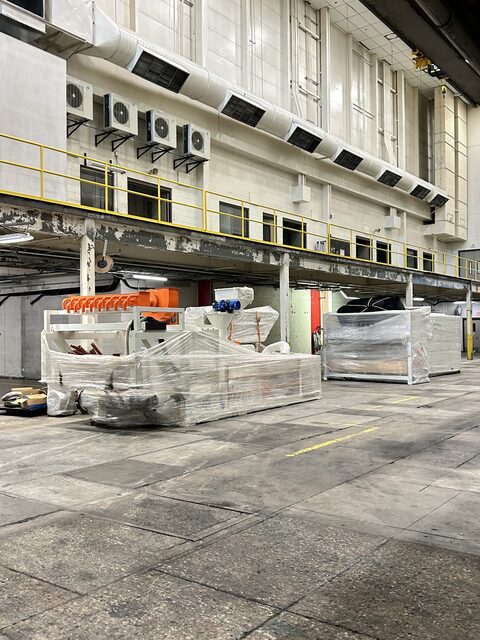 Shrink-wrapped process equipment staged on the floor, ready to move